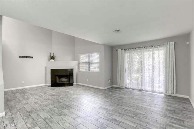 6250 W Flamingo Rd Unit 43, Las Vegas, NV 89103 - unfurnished living room with wood finished floors, baseboards, and a fireplace