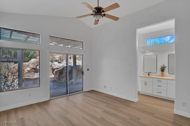 125 Firecreek Cir, Las Vegas, NV 89107 - unfurnished room featuring a sink, light wood-style floors, plenty of natural light, high vaulted ceiling, and ceiling fan