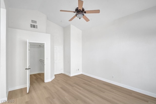 125 Firecreek Cir, Las Vegas, NV 89107 - unfurnished bedroom with light wood-style flooring, baseboards, high vaulted ceiling, a ceiling fan, and a spacious closet