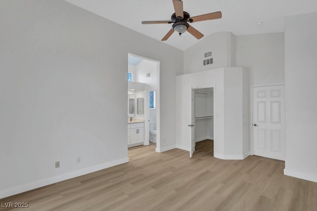 125 Firecreek Cir, Las Vegas, NV 89107 - unfurnished bedroom with high vaulted ceiling, light wood finished floors, a spacious closet, baseboards, and connected bathroom