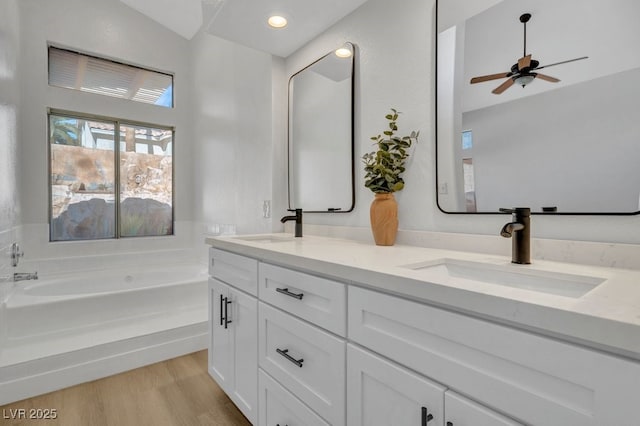 125 Firecreek Cir, Las Vegas, NV 89107 - full bathroom with double vanity, a bath, ceiling fan, and wood finished floors