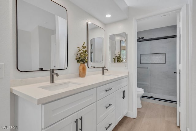 125 Firecreek Cir, Las Vegas, NV 89107 - full bathroom with toilet, double vanity, a stall shower, and wood finished floors