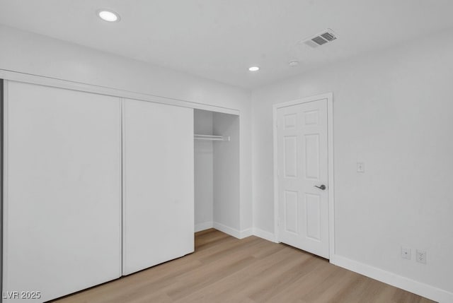 125 Firecreek Cir, Las Vegas, NV 89107 - unfurnished bedroom featuring light wood-style floors, a closet, baseboards, and recessed lighting