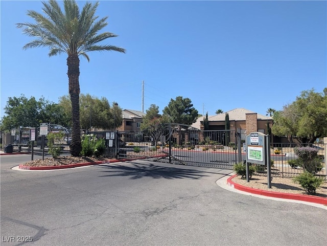 6650 W Warm Springs Rd Unit 2159, Las Vegas, NV 89118 - view of asphalt road with a gate, a gated entry, and curbs