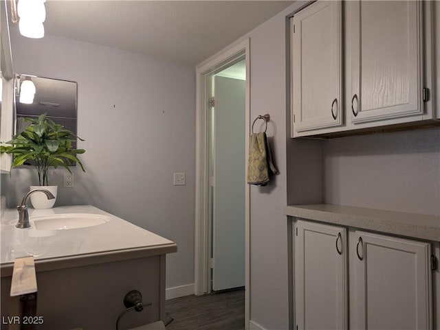 6650 W Warm Springs Rd Unit 2159, Las Vegas, NV 89118 - bathroom with vanity, baseboards, and wood finished floors