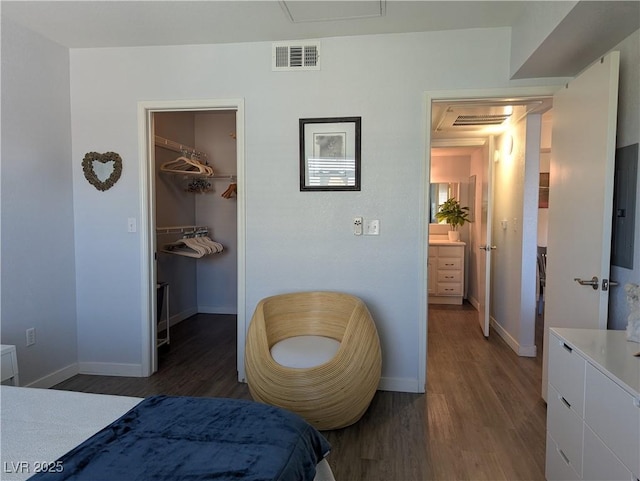 6650 W Warm Springs Rd Unit 2159, Las Vegas, NV 89118 - bedroom with wood finished floors, baseboards, a walk in closet, and a closet
