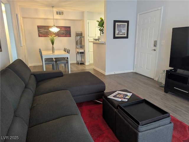 6650 W Warm Springs Rd Unit 2159, Las Vegas, NV 89118 - living room featuring wood finished floors, a chandelier, and baseboards