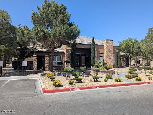 6650 W Warm Springs Rd Unit 2159, Las Vegas, NV 89118 - view of front facade featuring stucco siding and uncovered parking