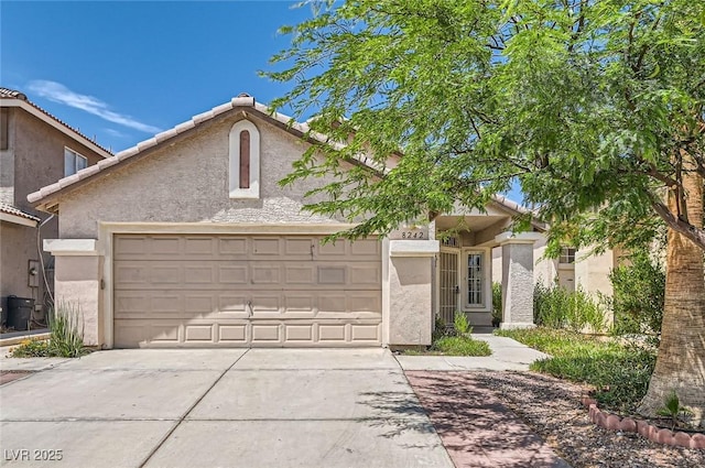 8242 Tribute Ln, Las Vegas, NV 89147 - view of front of home with a garage, concrete driveway, and stucco siding