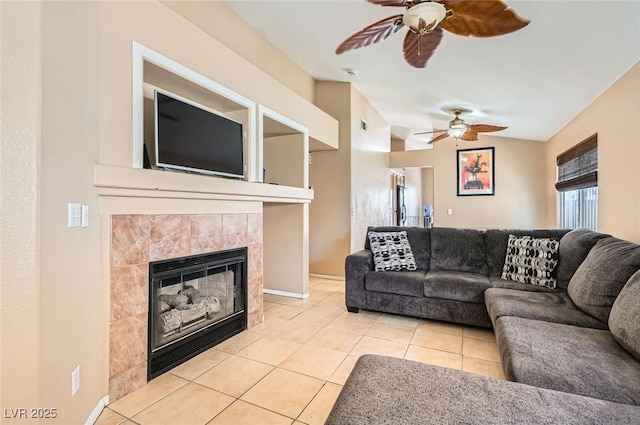 8242 Tribute Ln, Las Vegas, NV 89147 - living area featuring ceiling fan, tile patterned flooring, a tiled fireplace, and baseboards