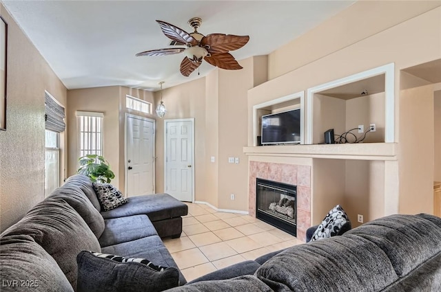 8242 Tribute Ln, Las Vegas, NV 89147 - living area featuring light tile patterned floors, a ceiling fan, a fireplace, and baseboards