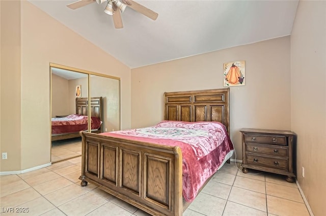 8242 Tribute Ln, Las Vegas, NV 89147 - bedroom with light tile patterned flooring, lofted ceiling, a closet, baseboards, and a ceiling fan