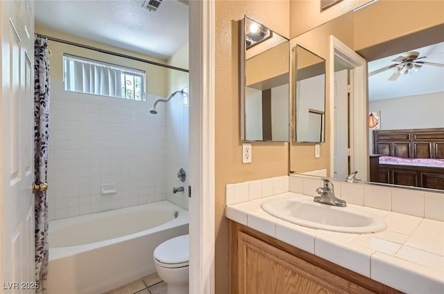 8242 Tribute Ln, Las Vegas, NV 89147 - ensuite bathroom featuring shower / tub combo, vanity, toilet, ceiling fan, and tile patterned floors