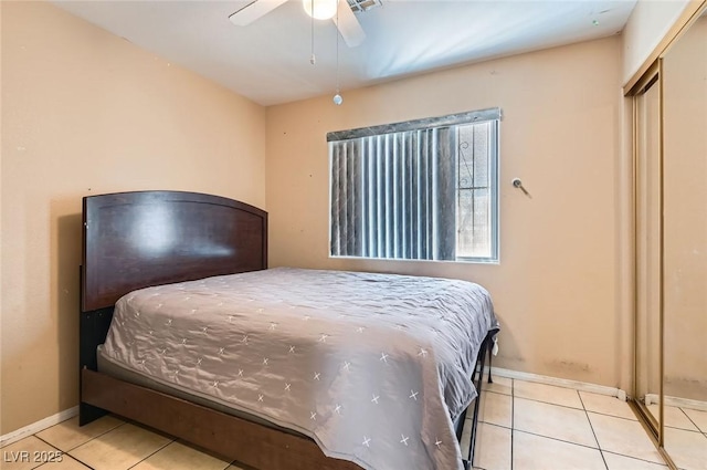 8242 Tribute Ln, Las Vegas, NV 89147 - bedroom with tile patterned floors, baseboards, a ceiling fan, and a closet