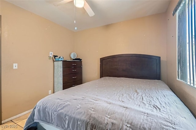 8242 Tribute Ln, Las Vegas, NV 89147 - tiled bedroom featuring ceiling fan and baseboards
