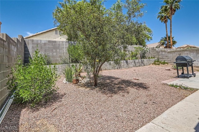8242 Tribute Ln, Las Vegas, NV 89147 - fenced backyard featuring a patio