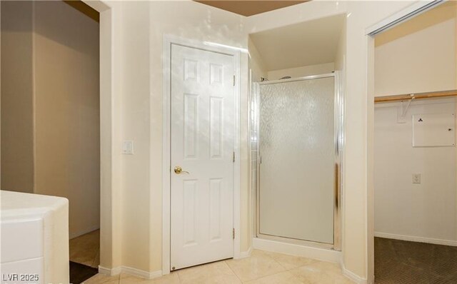 11204 Newbury Hills Ave, Las Vegas, NV 89138 - bathroom featuring a stall shower, baseboards, a spacious closet, and tile patterned floors