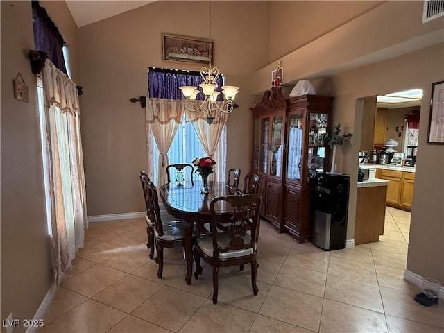 5517 Rock Creek Ln, Las Vegas, NV 89130 - dining space featuring a chandelier, light tile patterned floors, high vaulted ceiling, and baseboards