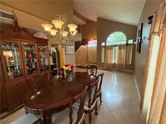 5517 Rock Creek Ln, Las Vegas, NV 89130 - dining space featuring lofted ceiling, light tile patterned floors, a chandelier, and baseboards