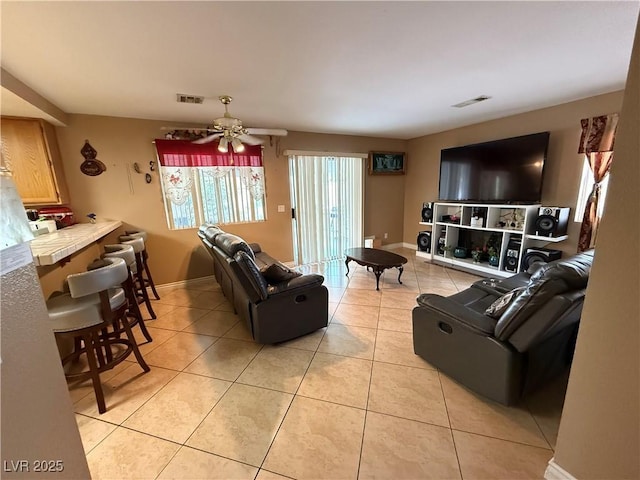 5517 Rock Creek Ln, Las Vegas, NV 89130 - living area with light tile patterned floors, ceiling fan, and baseboards