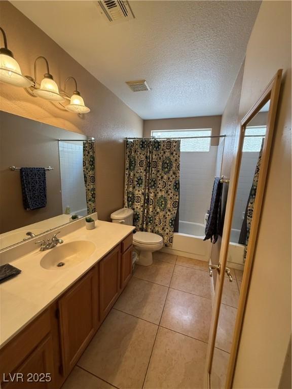 5517 Rock Creek Ln, Las Vegas, NV 89130 - full bath with vanity, toilet, shower / bathtub combination with curtain, tile patterned floors, and a textured ceiling
