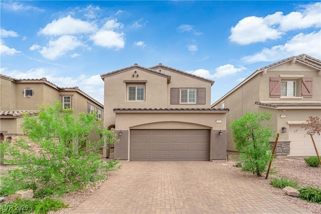 872 Pointe Arbor St, Henderson, NV 89011 - mediterranean / spanish-style house featuring an attached garage, stucco siding, decorative driveway, and a tile roof