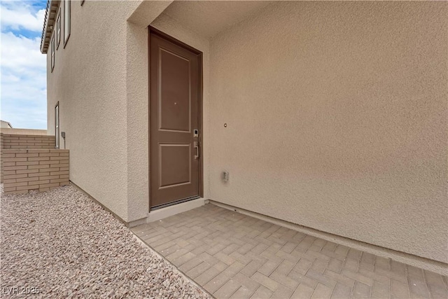 872 Pointe Arbor St, Henderson, NV 89011 - view of exterior entry with stucco siding and a patio area