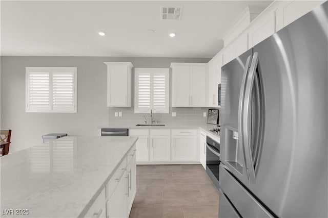 872 Pointe Arbor St, Henderson, NV 89011 - kitchen with appliances with stainless steel finishes, a sink, decorative backsplash, white cabinetry, and recessed lighting