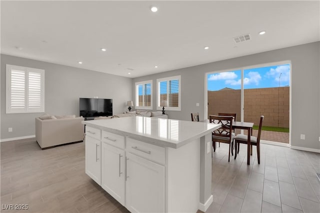 872 Pointe Arbor St, Henderson, NV 89011 - kitchen with a center island, baseboards, recessed lighting, white cabinets, and light countertops