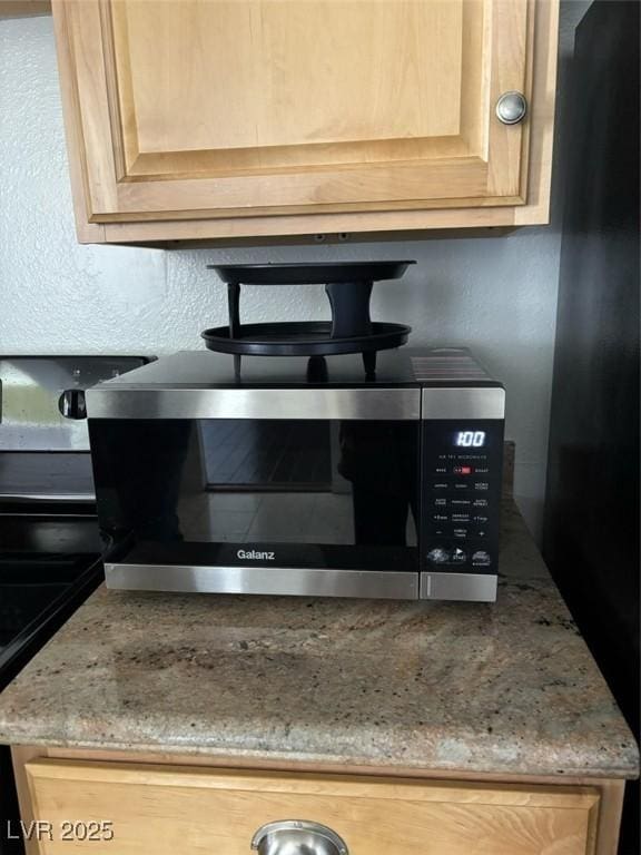 3930 University Center Dr Unit 702, Las Vegas, NV 89119 - kitchen view of stainless steel microwave and light stone countertops