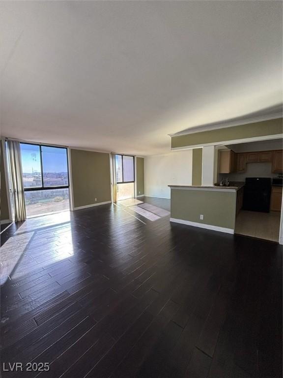 3930 University Center Dr Unit 702, Las Vegas, NV 89119 - unfurnished living room with wood finished floors and baseboards