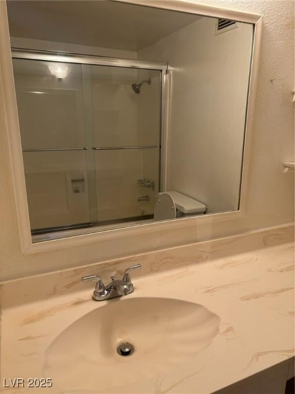 3930 University Center Dr Unit 702, Las Vegas, NV 89119 - full bath with vanity and shower / bath combination with glass door