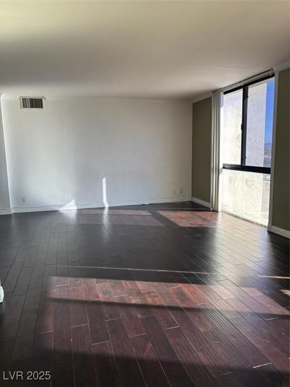 3930 University Center Dr Unit 702, Las Vegas, NV 89119 - spare room with hardwood / wood-style flooring, baseboards, and a wall of windows