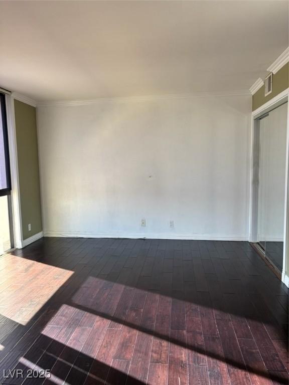 3930 University Center Dr Unit 702, Las Vegas, NV 89119 - unfurnished room featuring dark wood-style floors, crown molding, and baseboards