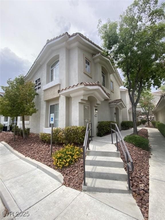 1511 Cardinal Peak Ln Unit 201, Las Vegas, NV 89144 - view of front of home featuring a tile roof and stucco siding