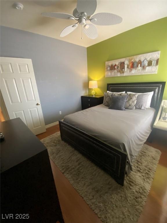 1511 Cardinal Peak Ln Unit 201, Las Vegas, NV 89144 - bedroom with wood finished floors, ceiling fan, and baseboards