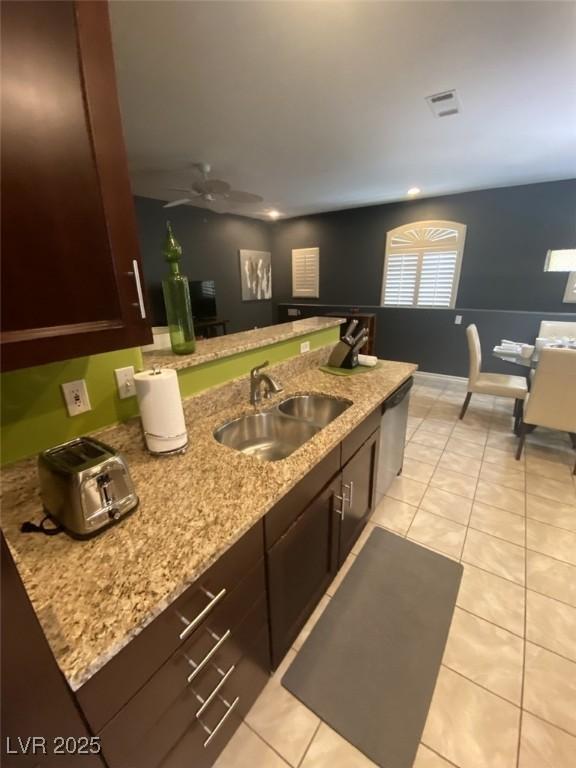 1511 Cardinal Peak Ln Unit 201, Las Vegas, NV 89144 - kitchen with a sink, light stone counters, and light tile patterned flooring