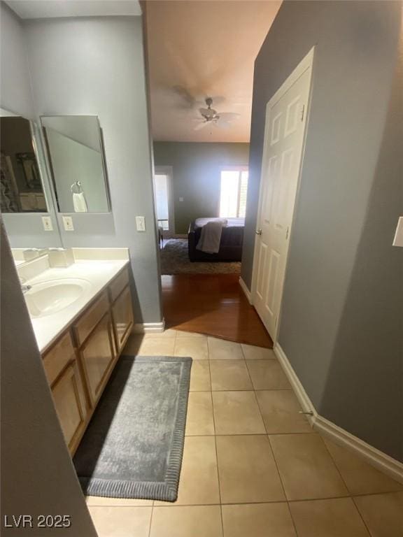 1511 Cardinal Peak Ln Unit 201, Las Vegas, NV 89144 - bathroom with vanity, tile patterned flooring, baseboards, connected bathroom, and a ceiling fan
