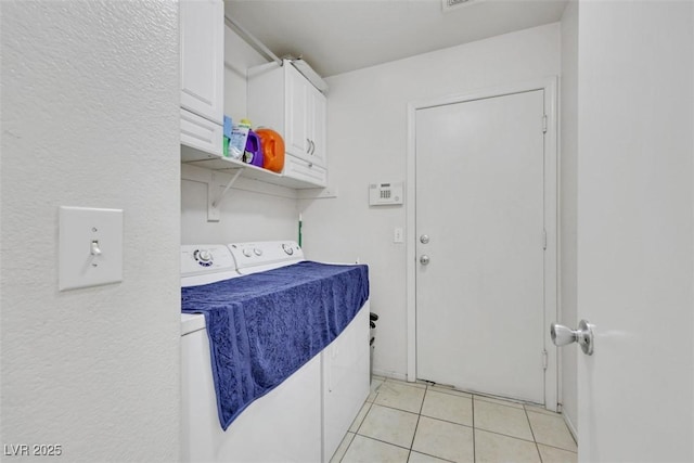 341 Waterwheel Falls Dr, Henderson, NV 89015 - laundry area featuring washer and dryer, light tile patterned flooring, and cabinet space