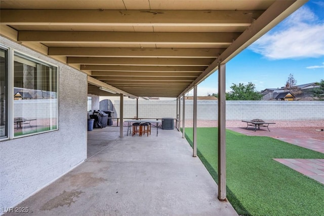 341 Waterwheel Falls Dr, Henderson, NV 89015 - fenced backyard with a patio, central AC, a fire pit, and outdoor dining area