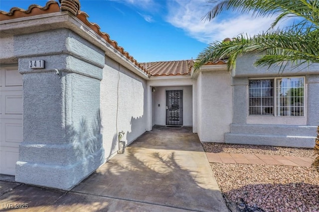 341 Waterwheel Falls Dr, Henderson, NV 89015 - doorway to property featuring stucco siding and a tile roof