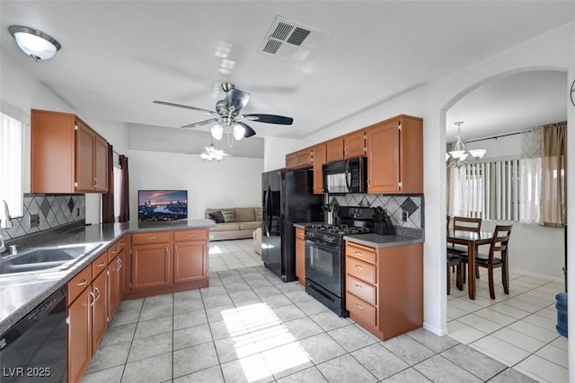 341 Waterwheel Falls Dr, Henderson, NV 89015 - kitchen featuring black appliances, a chandelier, backsplash, light tile patterned flooring, and open floor plan