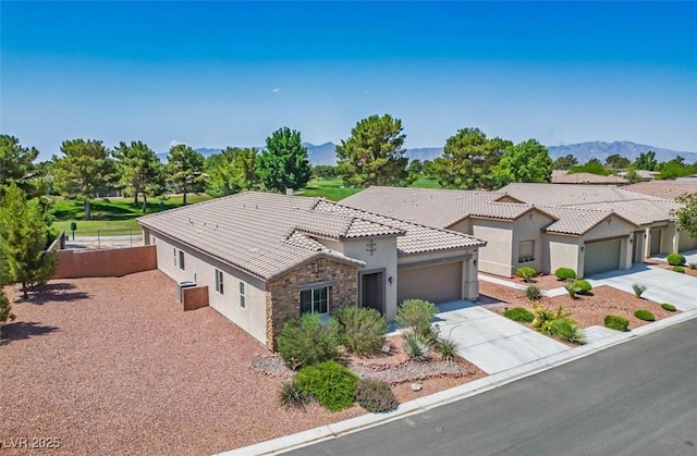 5235 E Ln Campana Dr, Pahrump, NV 89061 - mediterranean / spanish-style home featuring a garage, stucco siding, driveway, stone siding, and a tile roof