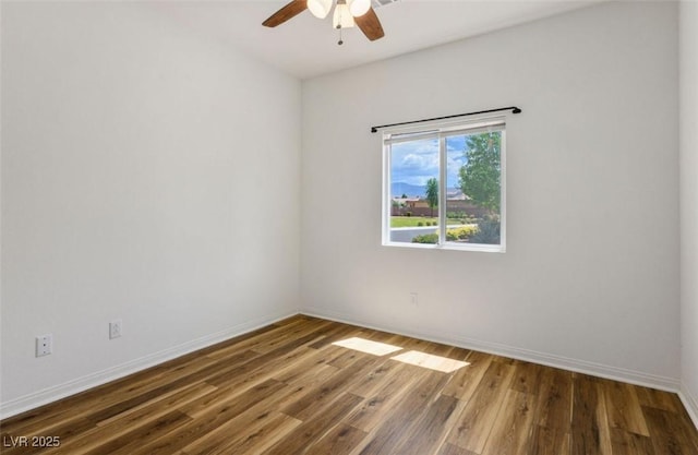 5235 E Ln Campana Dr, Pahrump, NV 89061 - unfurnished room featuring a ceiling fan, wood finished floors, and baseboards