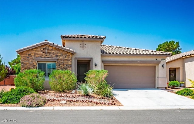 5235 E Ln Campana Dr, Pahrump, NV 89061 - mediterranean / spanish-style home featuring a garage, a tile roof, stucco siding, and stone siding