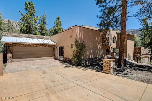 4162 Matterhorn Way, Las Vegas, NV 89124 - view of front facade with stucco siding, stone siding, driveway, and a standing seam roof