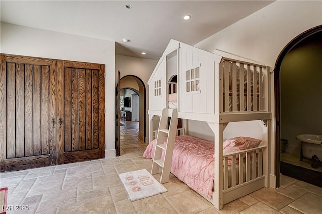 4162 Matterhorn Way, Las Vegas, NV 89124 - bedroom featuring arched walkways, stone tile flooring, and recessed lighting
