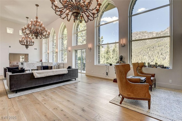 4162 Matterhorn Way, Las Vegas, NV 89124 - living room featuring a chandelier, a high ceiling, baseboards, and wood finished floors