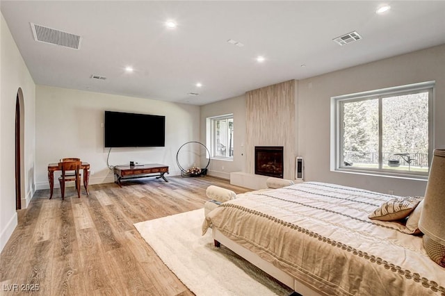 4162 Matterhorn Way, Las Vegas, NV 89124 - bedroom with wood finished floors, arched walkways, recessed lighting, baseboards, and a large fireplace