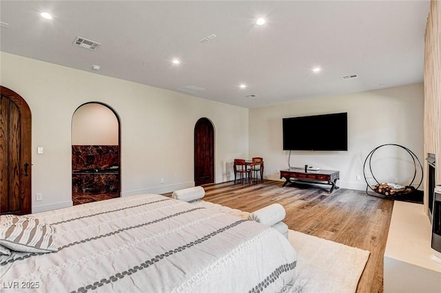 4162 Matterhorn Way, Las Vegas, NV 89124 - bedroom featuring arched walkways, wood finished floors, recessed lighting, and baseboards